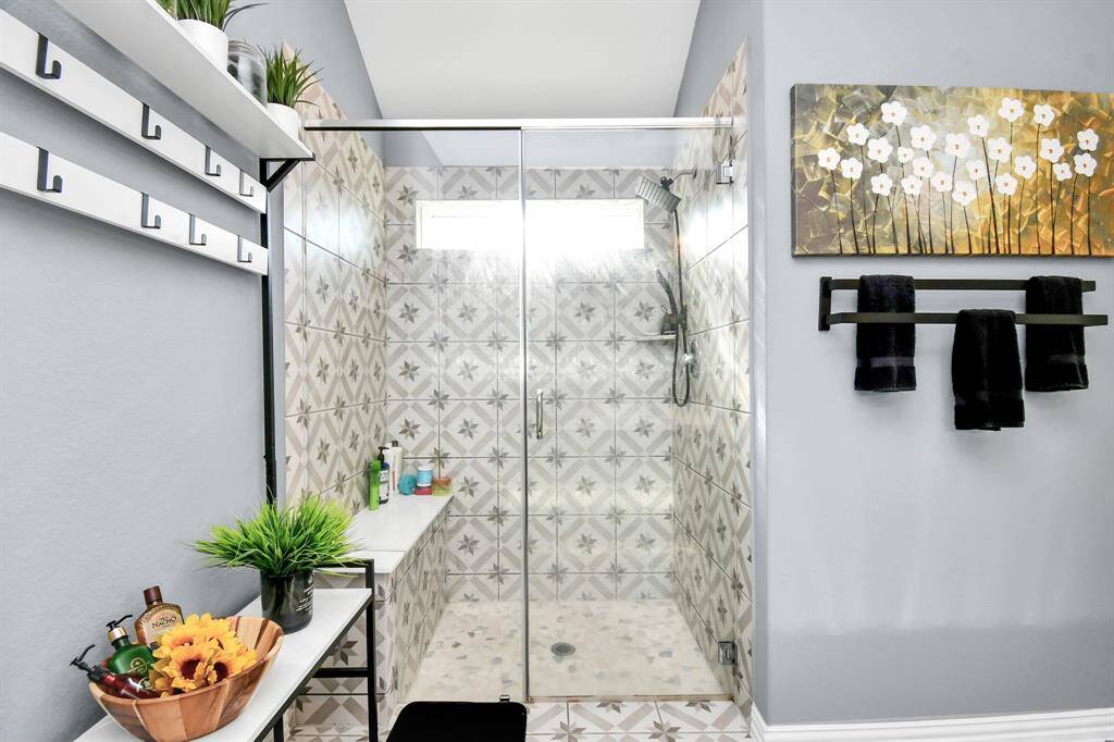This close-up of the shower reveals the thoughtful addition of bench seating for convenience and comfort!