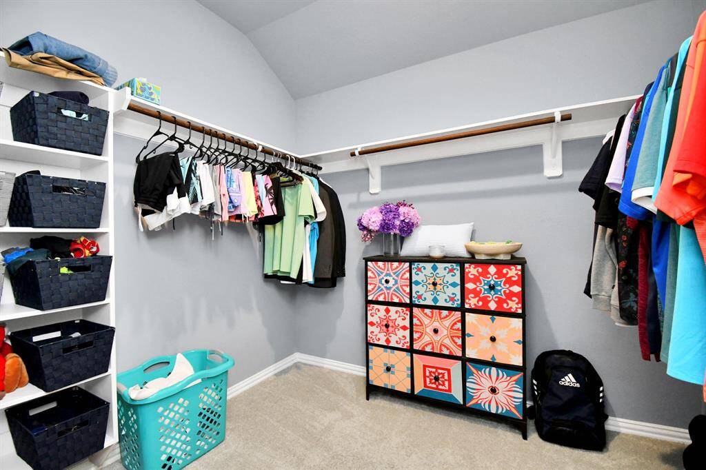 The primary suite walk-in closet is exceptionally spacious, and features built-in shelving for keeping everything neatly organized!