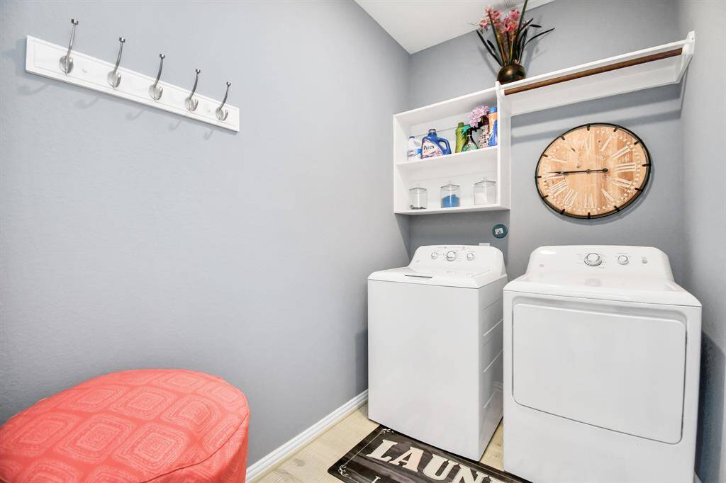 The utility room, conveniently located downstairs, offers both shelf and hanging areas to make life easier!