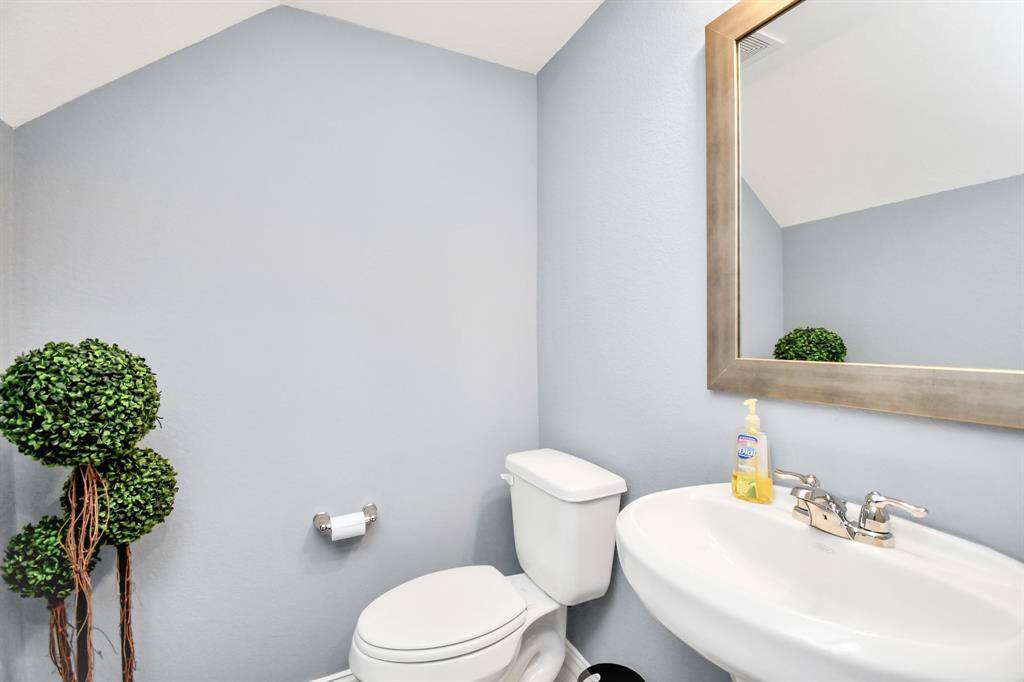 The lovely half bathroom is also located downstairs - perfect for guests or family!