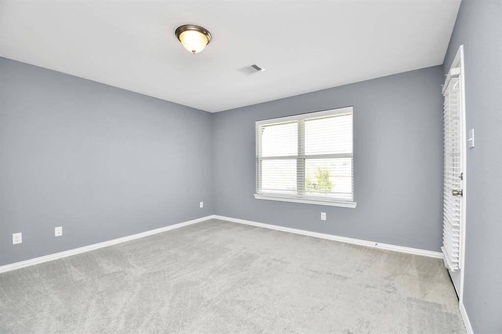 This inviting secondary bedroom, located upstairs, boasts its own private, covered balcony!