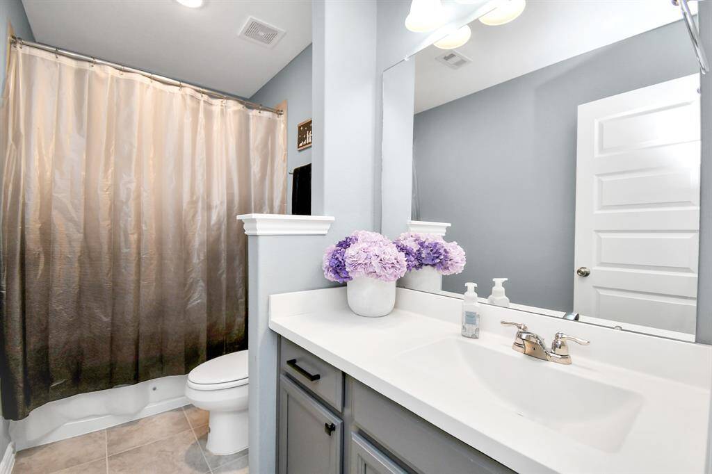 The second full bathroom upstairs is both bright and spacious, and features a convenient combination shower and bathtub!