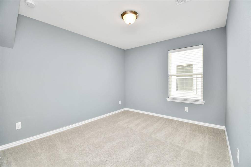The fourth bedroom upstairs is also spacious and filled with natural light, and offers a welcoming atmosphere with plenty of room for personalization!