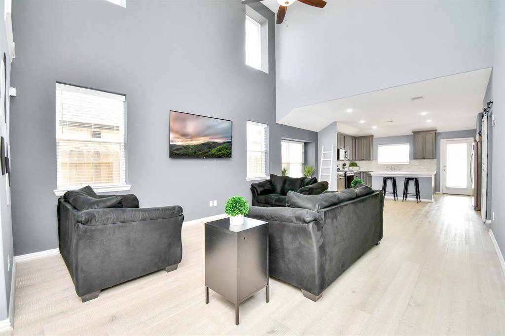 Gorgeous solid wood flooring flows seamlessly throughout the downstairs living spaces, adding elegance to the interior!