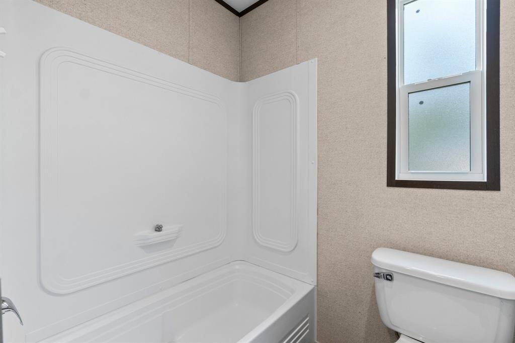 Secondary bathroom has a tub w/shower.