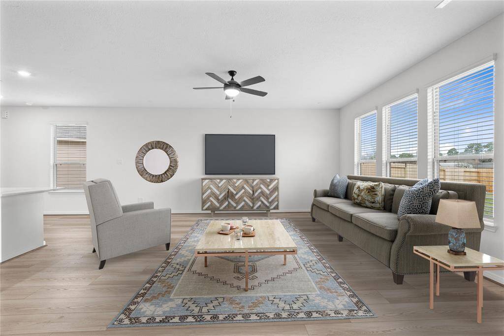 Gather the family and guests together in your lovely family room! Featuring high ceilings, ceiling fan, custom paint, gorgeous vinyl plank flooring, and a wall of windows that provide plenty of natural lighting throughout the day!