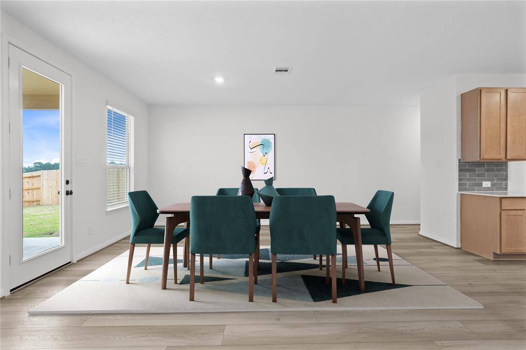 Make memories gathered around the table with your family and friends! This dining room features high ceilings, recessed lighting, large window with privacy blinds, vinyl plank flooring, and neutral paint!