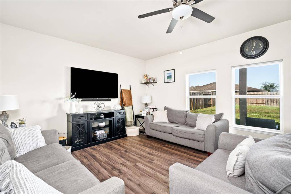 A bright and airy living room with wide windows invites natural light to flood the space, creating a warm and open atmosphere. The expansive windows offer stunning views while enhancing the room's sense of openness and comfort.