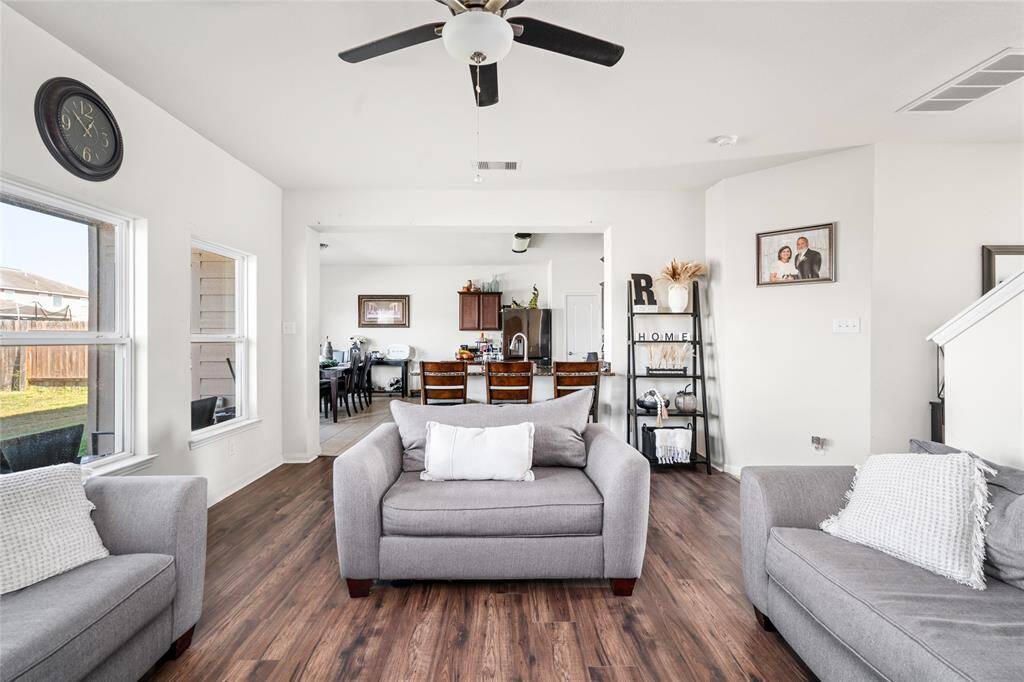 This home features a free-flowing, open-concept floor plan that seamlessly connects the living room to the kitchen. The spacious layout encourages easy movement and conversation, making it perfect for entertaining or enjoying family time. The design creates a bright, airy atmosphere where the heart of the home feels both expansive and inviting.