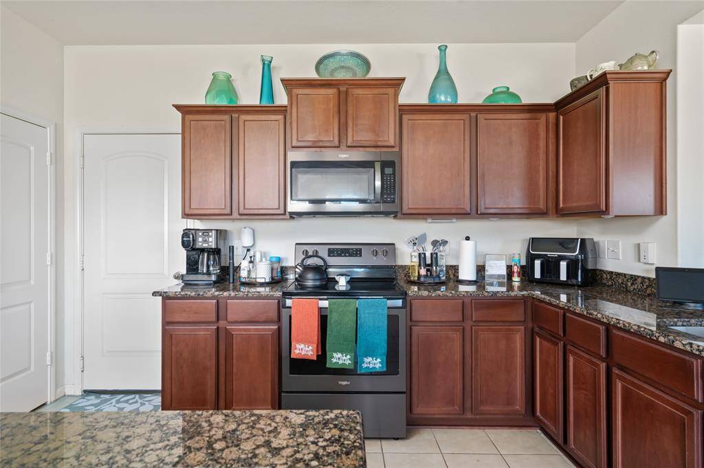 This spacious kitchen is designed for both style and functionality, featuring ample counter space and plenty of cabinetry for storage. It's an ideal space for preparing meals, entertaining guests, and creating lasting memories with family.