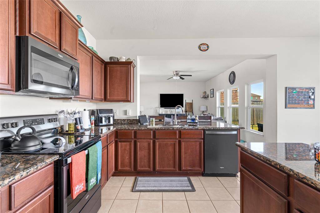 From the kitchen, you have a clear view into the inviting living room, creating an open and connected space. The seamless flow between the two areas makes it easy to engage with family or guests while preparing meals.