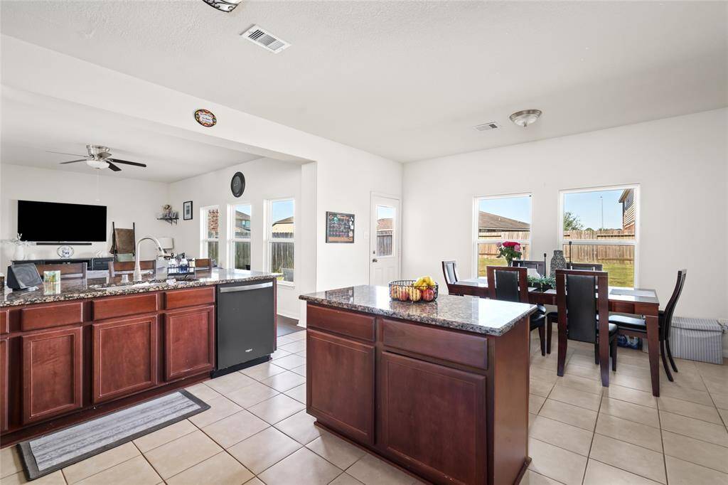 From the kitchen, you can easily see into the bright dining area, creating a seamless transition between cooking and dining. The open layout enhances the flow of the space, making it perfect for family meals and entertaining.