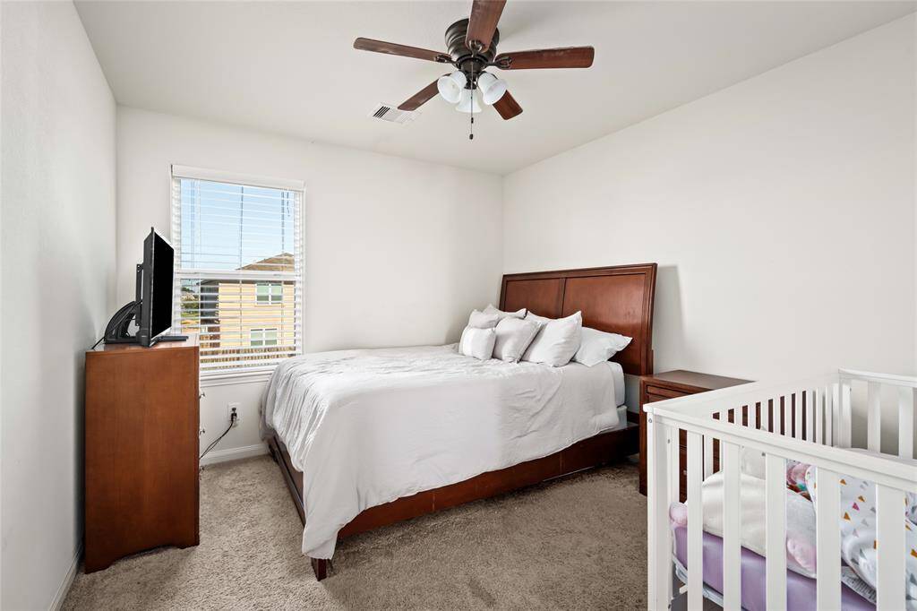 This cozy secondary bedroom is perfect for guests, children, or a home office. With plenty of natural light and ample space, it offers versatility and comfort, making it an ideal room for relaxation or productivity. ONe of the secondary bedrooms is currently being used as a storage room.
