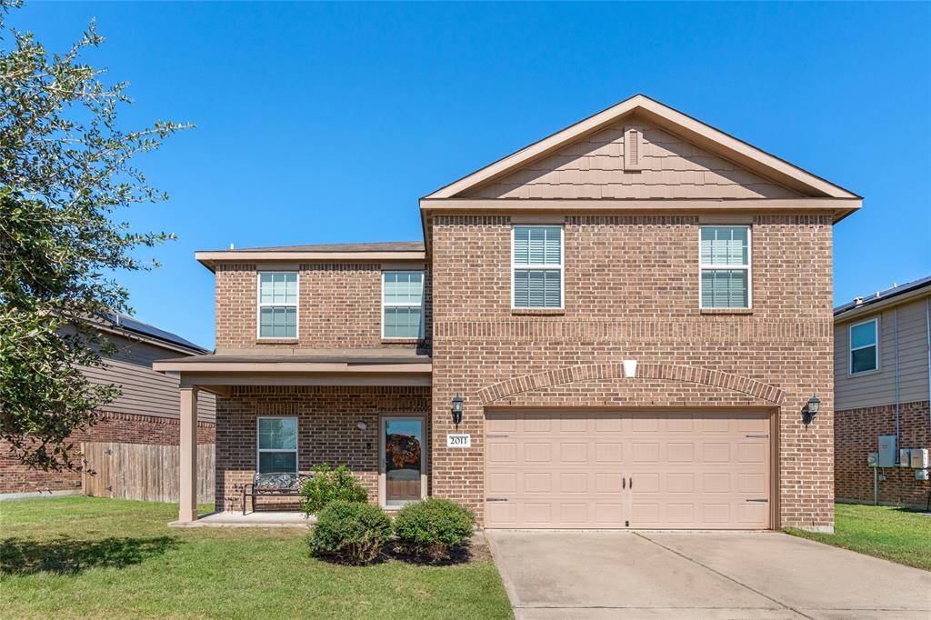A beautifully maintained front lawn showcases lush, green grass with crisp edges, vibrant plants, and tidy flower beds. It’s a welcoming, pristine space that enhances the home’s curb appeal.