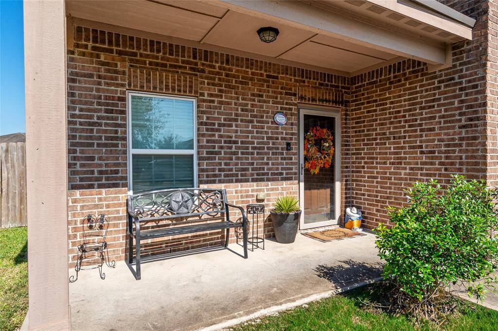 A covered front porch provides a welcoming, shaded space perfect for relaxing and enjoying the outdoors. With ample room for seating, it’s an inviting spot to unwind, entertain, or greet guests, adding charm and warmth to the home’s entrance.