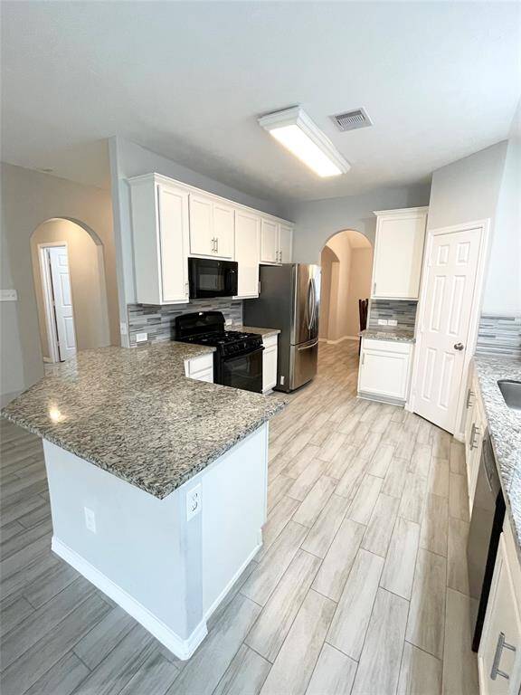 Spacious kitchen with bar island.