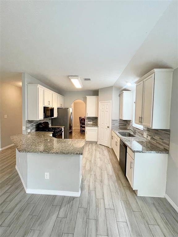 Open concept kitchen with beautiful granite counter tops.