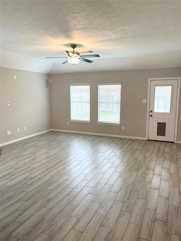 Living room is very spacious and all the flooring the home is beautiful wood tile!