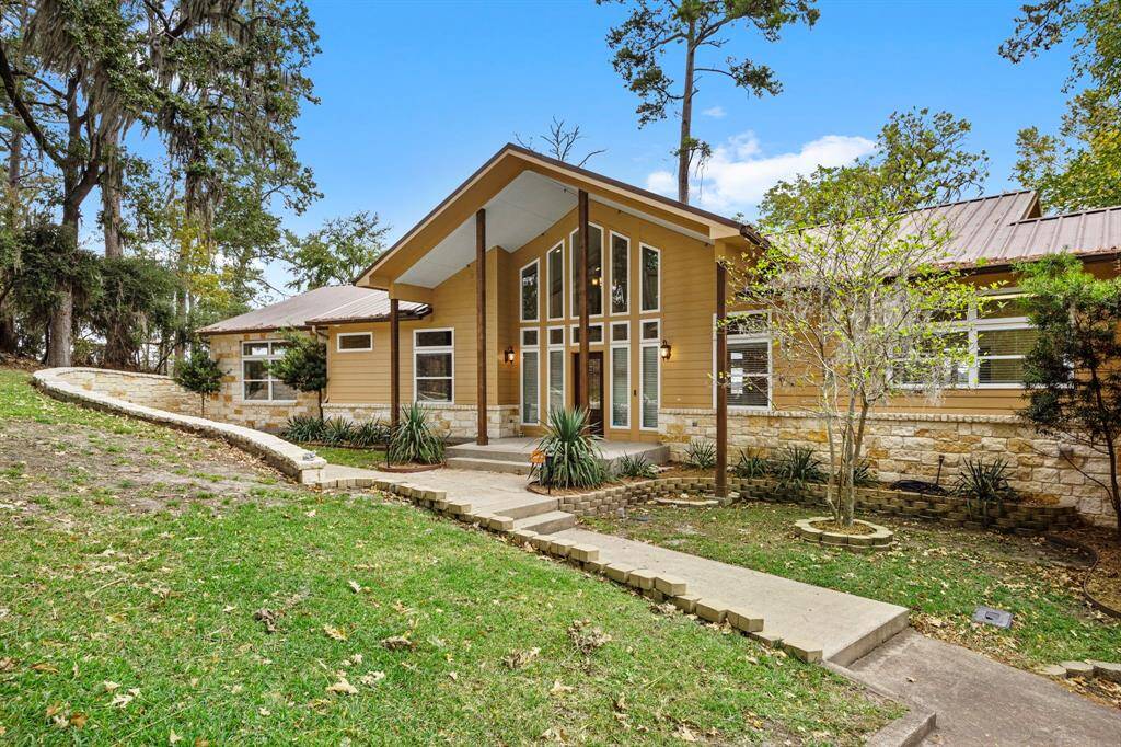 Front of home.  Note stone pathway leading around into the back of the property.  The home also features a durable and long-lasting metal roof.