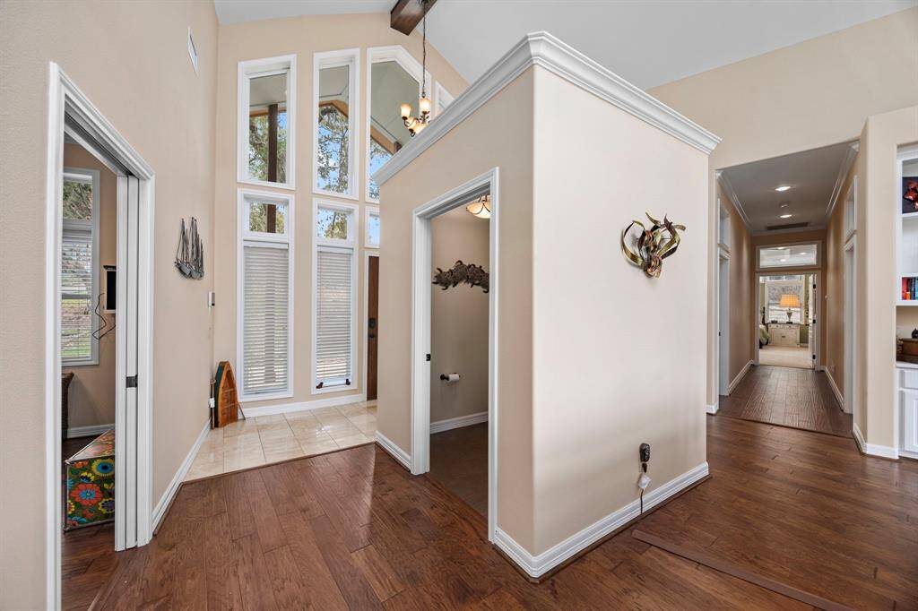 A stand-alone half-bath is conveniently located just inside the entry, providing easy access for guests and everyday use.  Note - Home Office/Study is through opening on left side of photo.  Hallway leading to bedrooms on right side of photo.