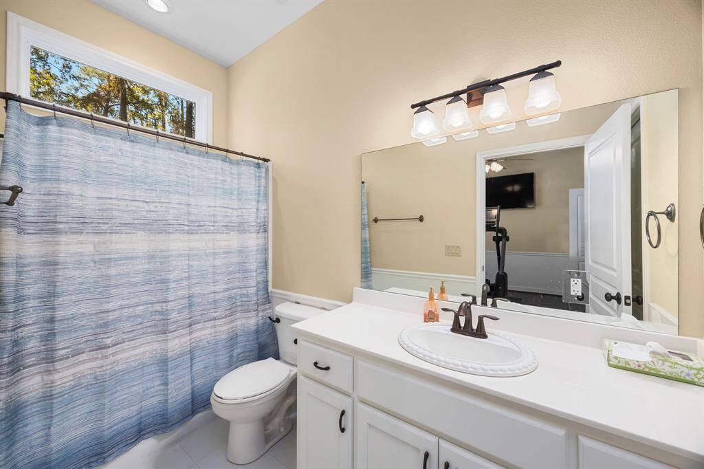 Bedroom #3.  En-suite bathroom with Tub/Shower combination and transom window for natural light.