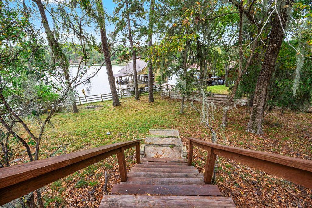 Steps off of back deck provides convenient access down to the boathouse.