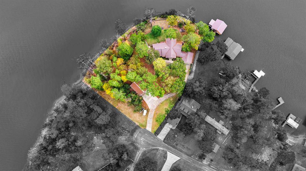 Nestled on a secluded 2-acre (4 contiguous lots) peninsula in Trinity, TX, this estate offers over 570’ of waterfront shoreline, 150' of wood bulkhead, and a Boathouse located on deep water.