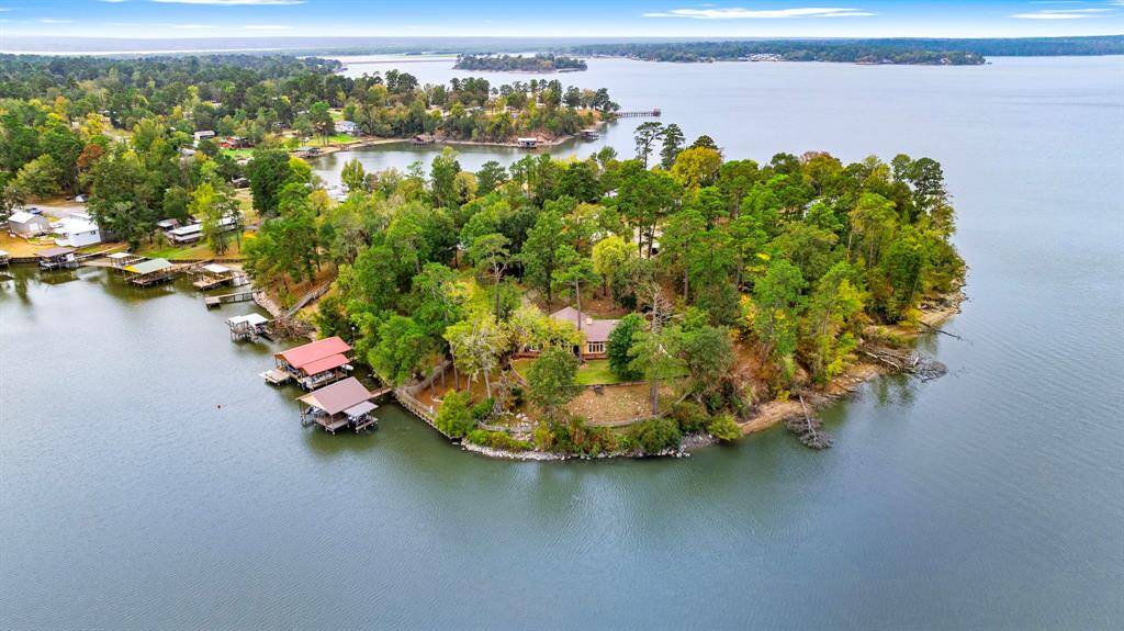 350 N Point Drive in Trinity, TX, offers unparalleled privacy on a stunning point that overlooks the serene waters of Lake Livingston. This unique property provides spectacular panoramic views, creating the perfect lakeside retreat surrounded by natural beauty.