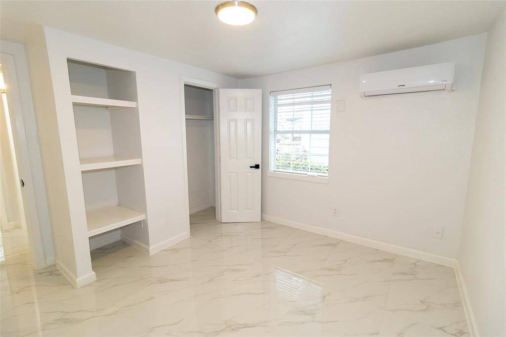 This is a bright, clean room featuring marble-like tiled flooring.