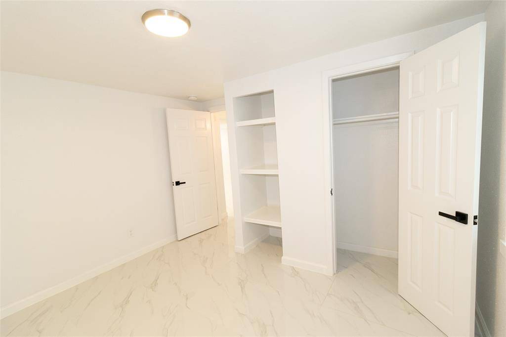 This is a bright, clean room featuring marble-like tiled flooring.