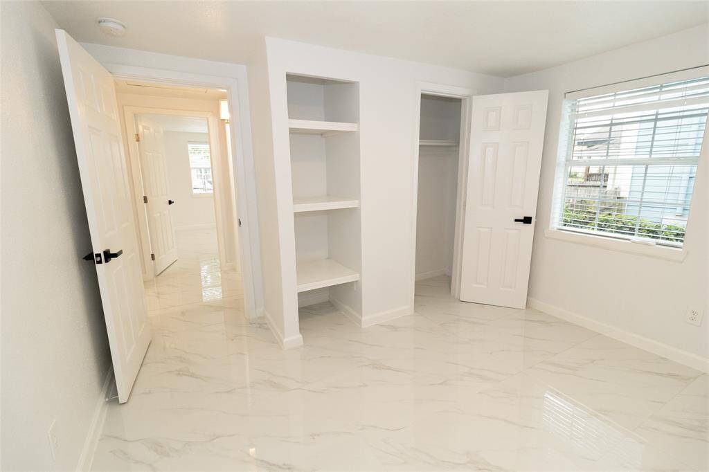 This is a bright, clean room featuring marble-like tiled flooring.
