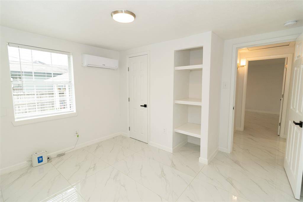 This is a bright, clean room featuring marble-like tiled flooring.