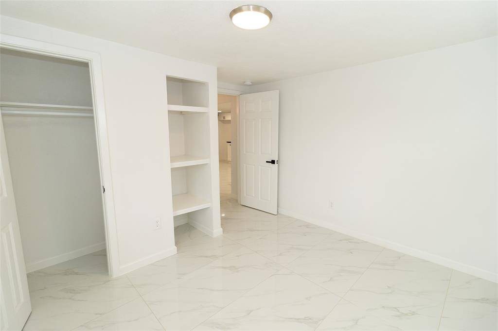 This is a bright, clean room featuring marble-like tiled flooring.