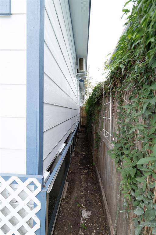 This is a narrow side yard featuring a pathway between the house.