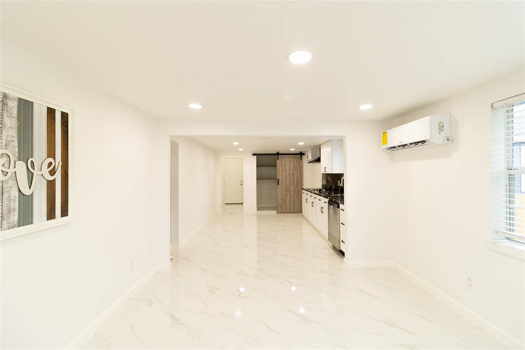 This is a bright, modern kitchen with sleek white marble flooring.
