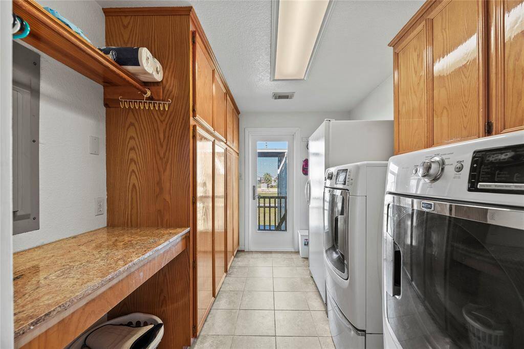 Large laundry room and plenty of cabinet storage.