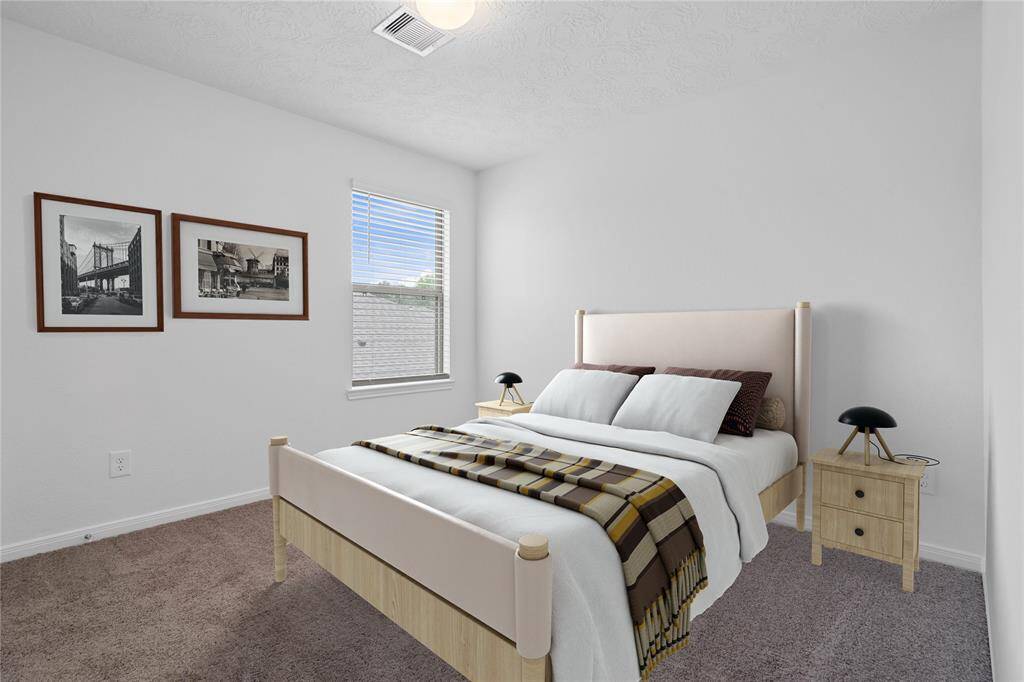 Secondary bedroom features plush carpet, neutral paint, lighting, large window with privacy blinds, and ample sized closet space.