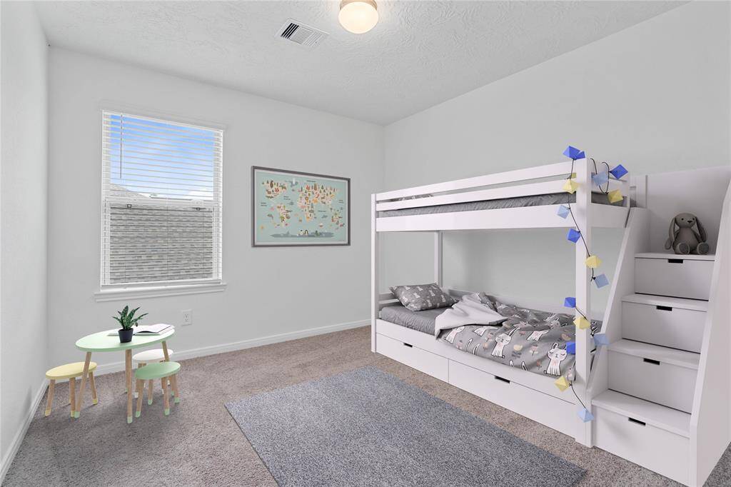 Secondary bedroom features plush carpet, neutral paint, lighting, large window with privacy blinds, and ample sized closet space.