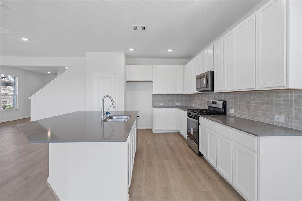 Additional view of this gorgeous spacious kitchen with Woodmont Belmont flat panel cabinetry.
