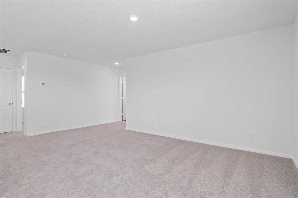 Come upstairs and enjoy a day of leisure in this fabulous loft! This is the perfect hangout spot or adult game room. This space features plush carpet, high ceiling, recessed lighting, and custom paint