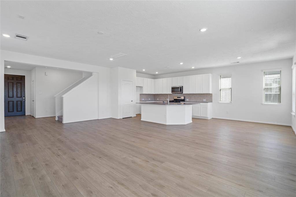 The open concept great room, dining, and kitchen makes for a impressive way to keep the party going and never miss a beat! The Great Room features large windows, 2" wood blinds, high ceilings, recessed lighting, and Layton Lake Vinyl Plank flooring!