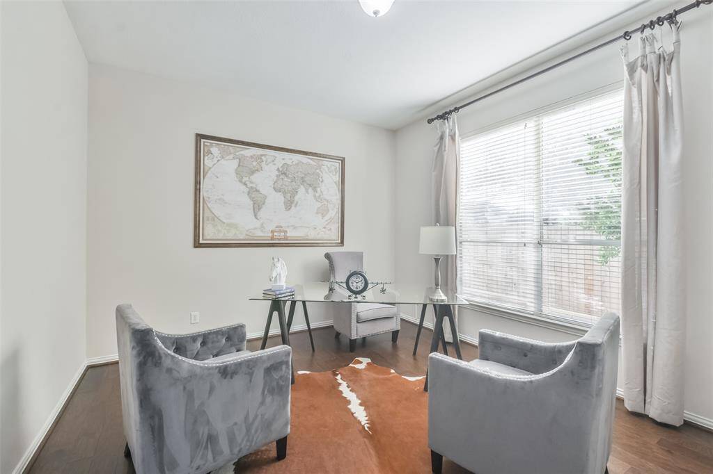 The study has French doors for privacy, wood floors, built-in bookcases, custom drapes, and 2” blinds.