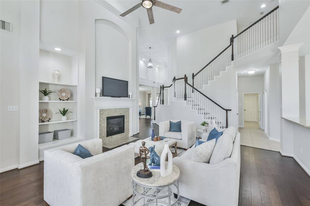 Notice the gas log fireplace with wood mantle and granite surround, and built-in bookshelves.