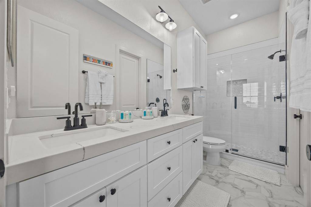 Look at this stunning Primary bathroom.  Complete with a walk in shower, double sinks, and quartz counter tops.
