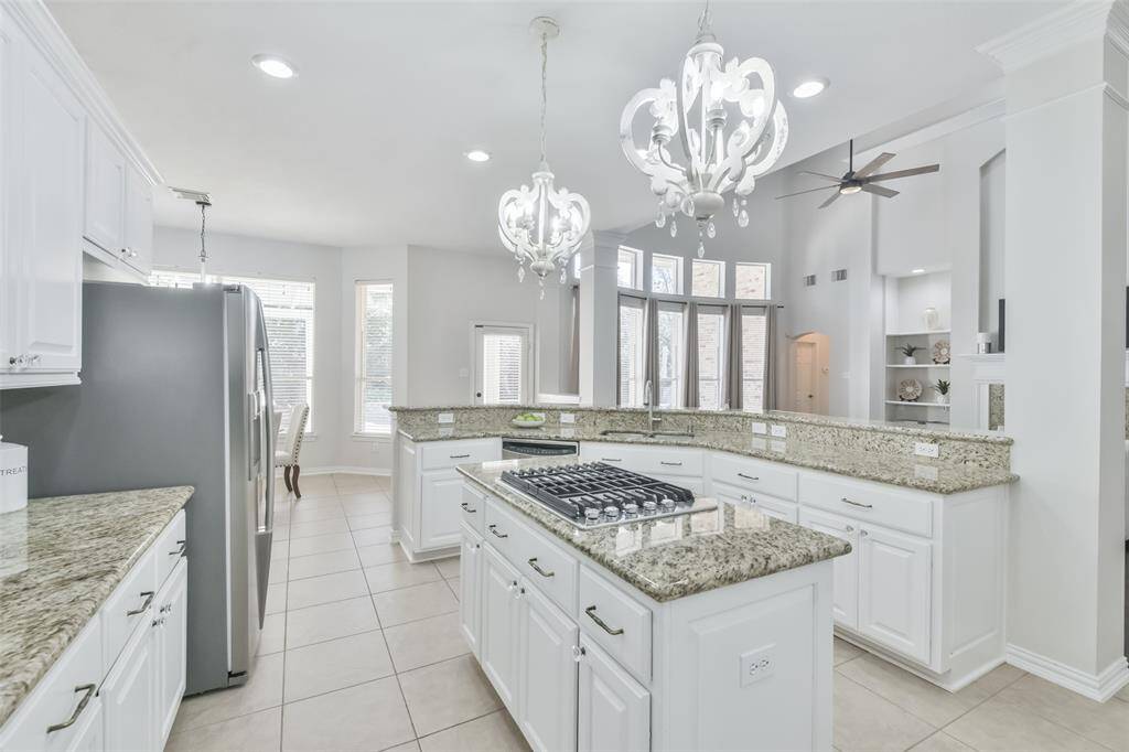 The kitchen has tile floors, granite counters and backsplash.