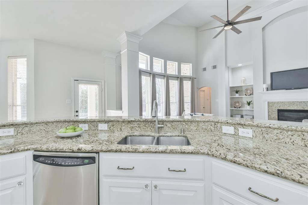 Notice the stainless steel sink with contemporary faucet.