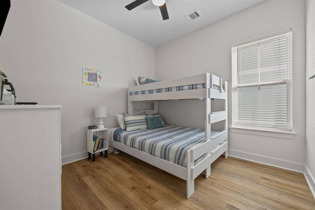 Third bedroom with wide plank laminate flooring for easy cleaning.