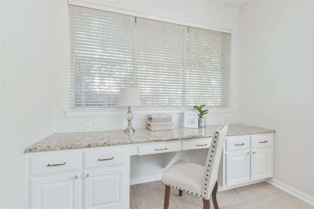 This room has a wonderful granite-topped desk and bar area with storage cabinets.