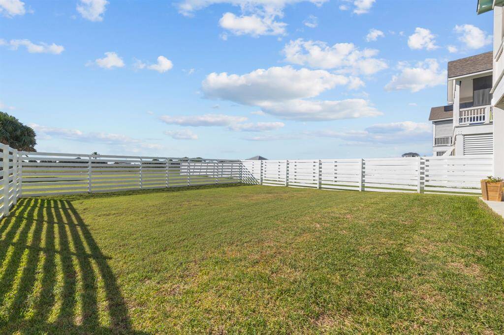 Fenced backyard with plenty of room for your own paradise.
