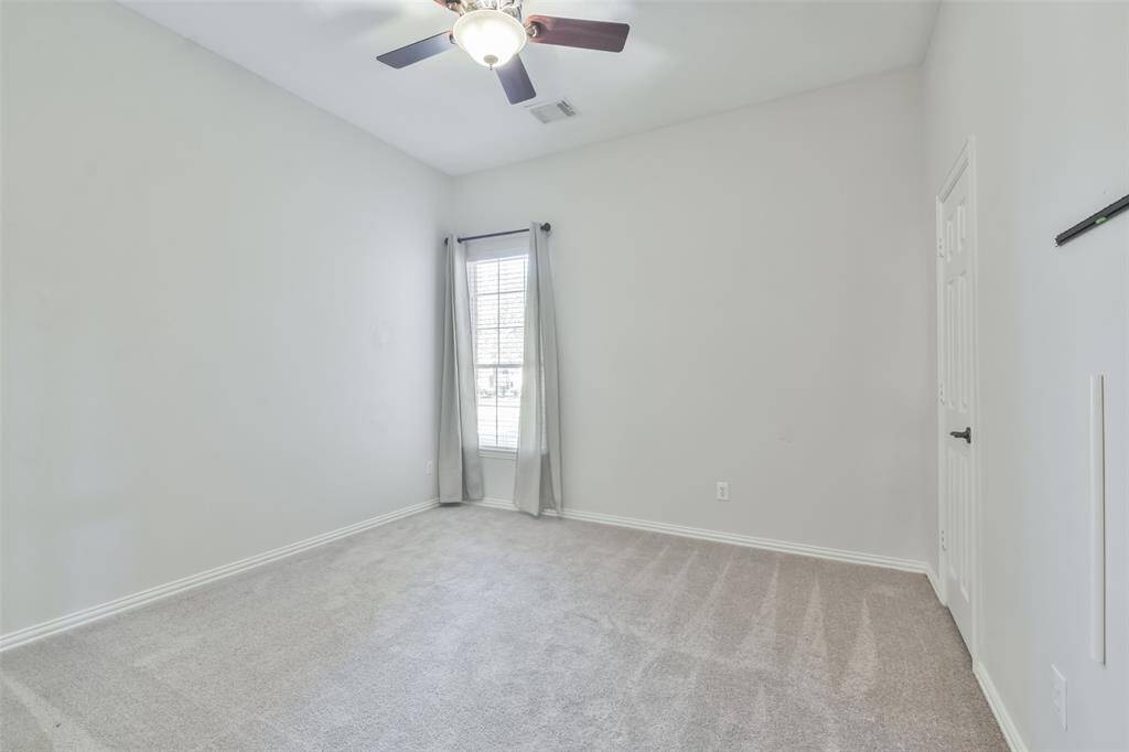 The 2nd bedroom downstairs has carpet, a ceiling fan, 2" blinds and a closet.